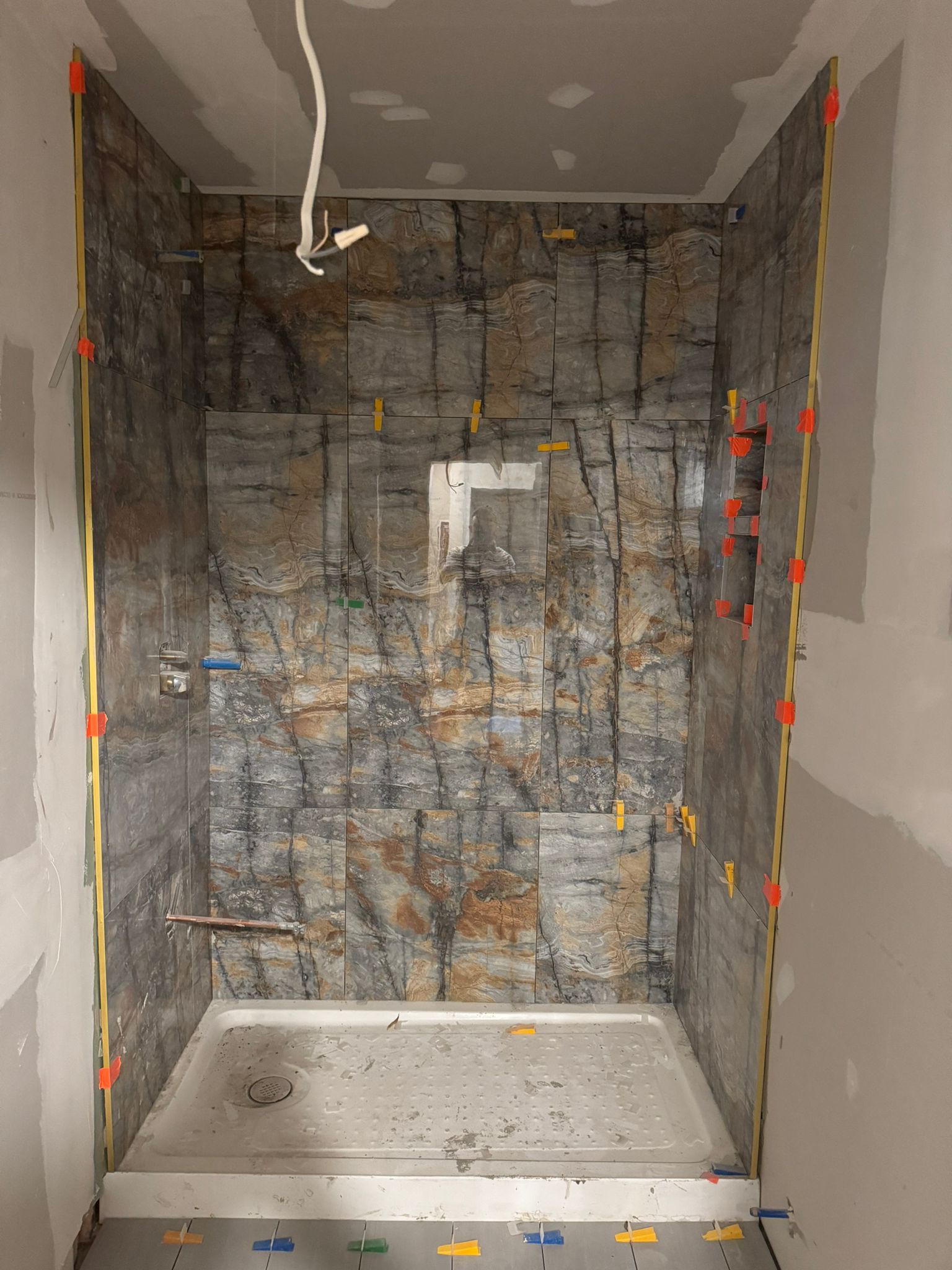 Walk-in shower tile installation in progress