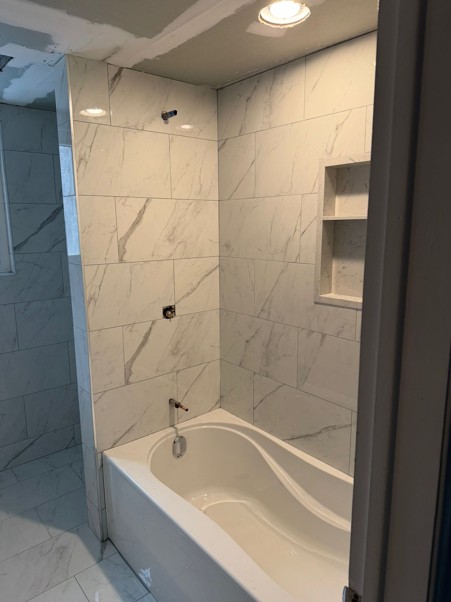 Condo bathroom marble tile installation
